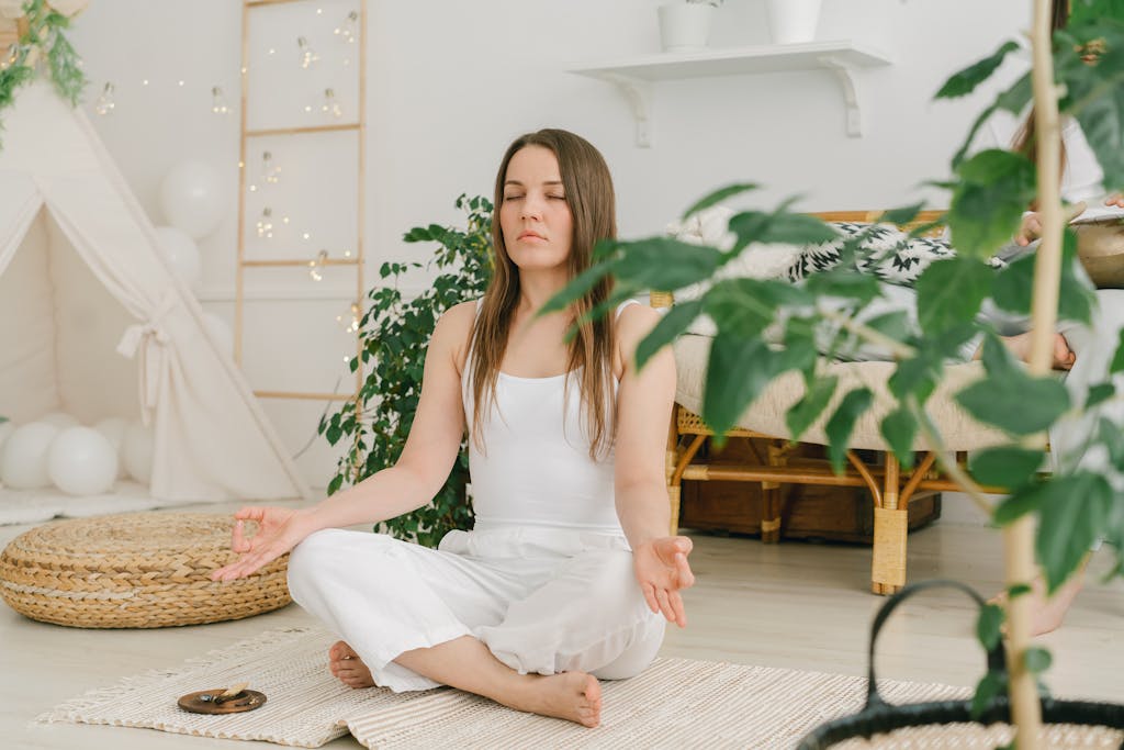 Peaceful meditation scene with a woman practicing mindfulness in a cozy, plant-filled indoor space.